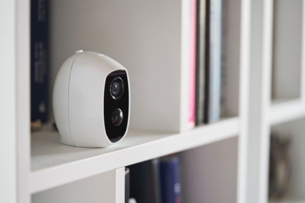 A smart camera sits on a shelf. 