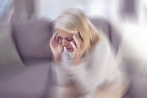 An older woman has a panic attack as the room swirls around her. 